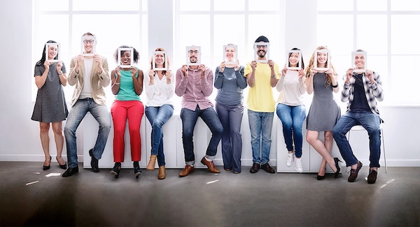 diverse group of users holding photo frames over faces